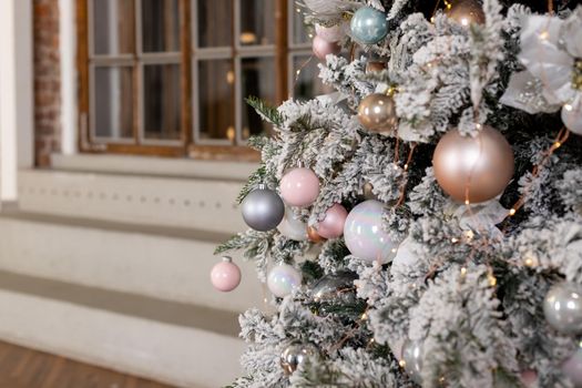 Christmas texture of white delicate Christmas tree and Christmas decorations, balls and ribbons, garland and lights.