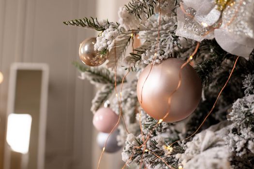 Christmas texture of white delicate Christmas tree and Christmas decorations, balls and ribbons, garland and lights.