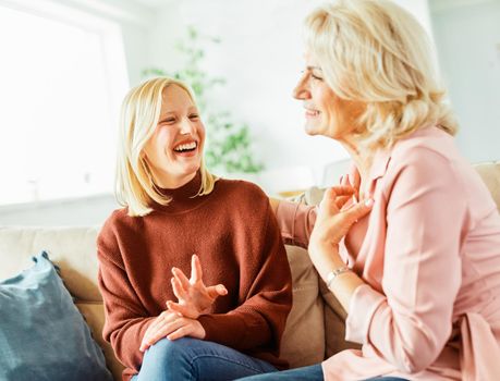 Portrait of Grandmother and granddaughter or daughter having fun bonding together and having conversation at home