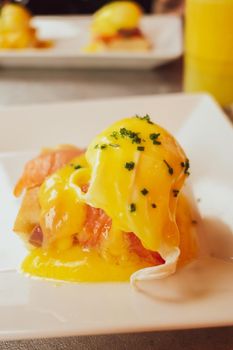 Restaurant service, food recipes and breakfast concept - Poached egg with salmon for brunch in a luxury restaurant