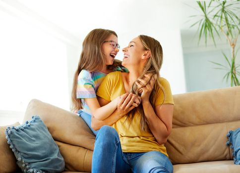 mother and daughter playing and having fun at home