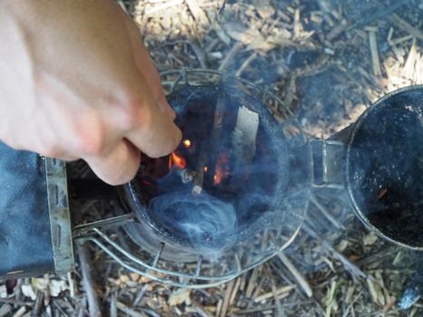 starting a bee smoker before harvesting honey hives in the farm.