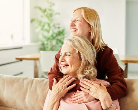 Portrait of Grandmother and granddaughter or daughter having fun hugging and bonding together at home