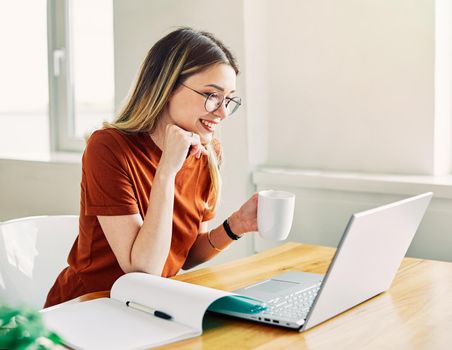 Portrait of a young girl using laptop at home