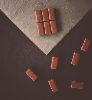 Sweet swiss chocolate candies on a stone tabletop, flatlay - desserts, confectionery and gluten-free organic food concept. All you need is chocolate