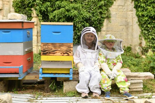 Children in protective suits at the beehive