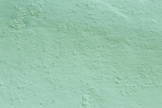 Green Textured Wall Background . The surface of the old pastel green plaster.