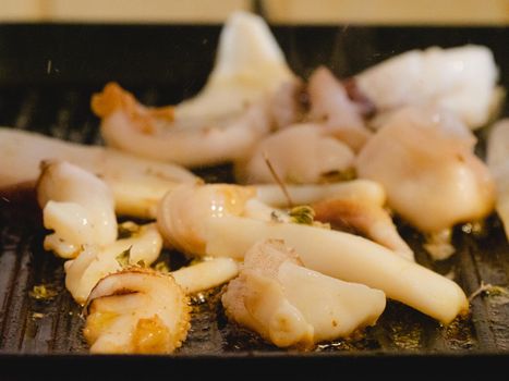 grilling a raw adriatic cuttlefish at home in Numana, Marche, Italy
