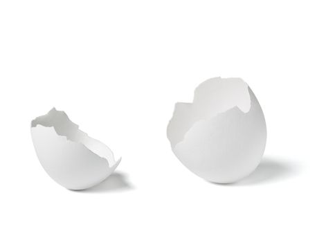 Close up of a broken white eggshell on white background