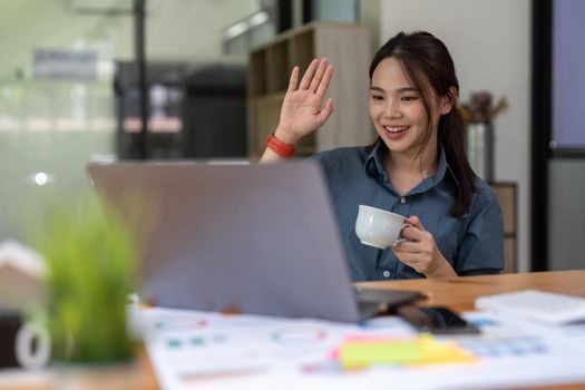 Business Woman with business partner via video call on laptop, remotely consult