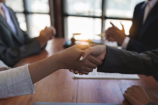 Business team and lawyer shaking hand after discussing about agreement contract. Law, legal services, advice, Justice concept.