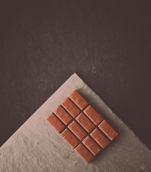 Sweet swiss chocolate candies on a stone tabletop, flatlay - desserts, confectionery and gluten-free organic food concept. All you need is chocolate