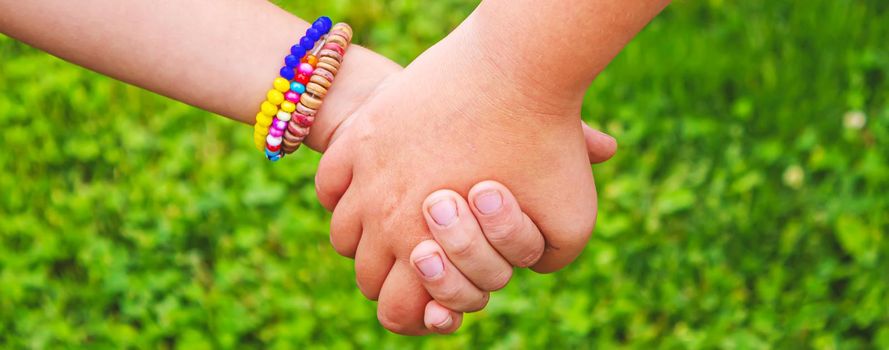 The children put their hands together. Selective focus. kids