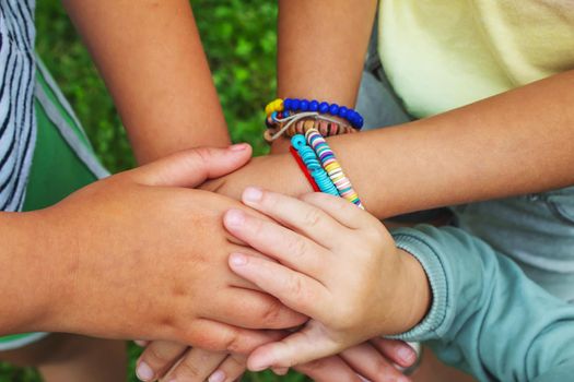 The children put their hands together. Selective focus. kids