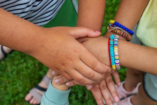 The children put their hands together. Selective focus. kids