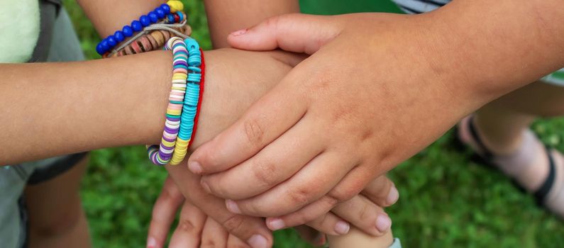 The children put their hands together. Selective focus. kids