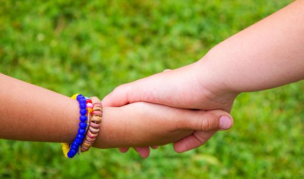 The children put their hands together. Selective focus. kids