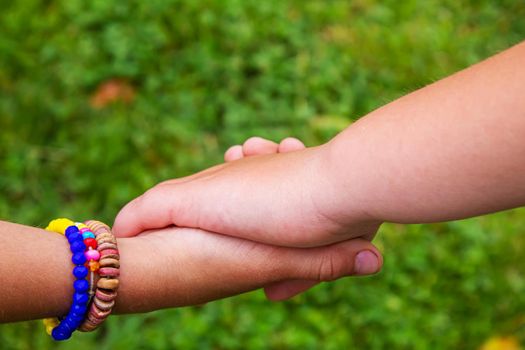 The children put their hands together. Selective focus. kids