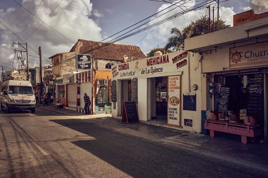 Playa del carmen, Mexico 20 august 2022: Characteristic street of the center of Playa del Carmen in Mexico with some of the typical restaurants and the normal traffic of people and local means of transport.