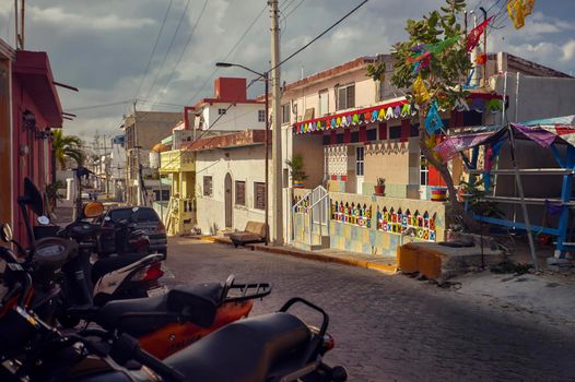 Isla Mujeres, Mexico 20 august 2022: Street view of a neighborhood of Isla Mujeres in Mexico: You can see the palaces and the colored houses that form the urbanism of this beautiful Caribbean island.