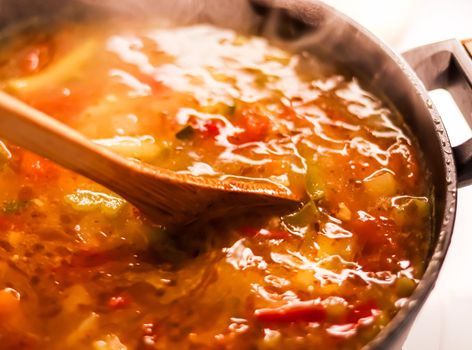 Cooking vegetable soup in saucepan, comfort food and homemade meal concept