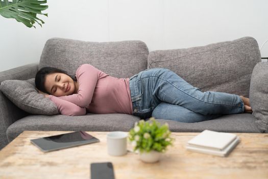 Young asian woman sleeping on sofa at home.