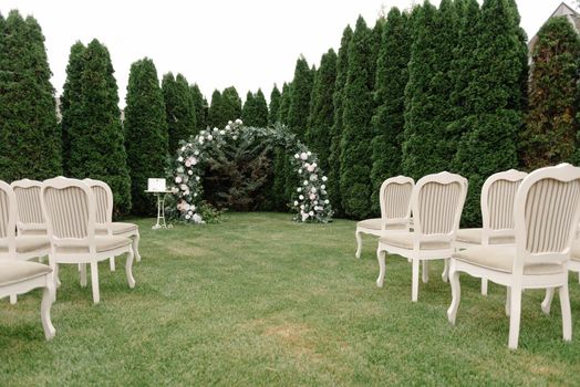 wedding location. Simple wedding location. Not rich. Beautifully decorated wedding ceremony location under a large oak tree, wide view..