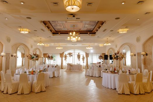 wedding stage decoration. a wedding hall in warm beige tones.