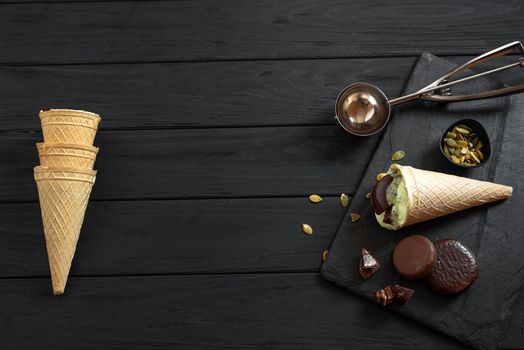 The process of making homemade ice cream on a black background. Ingredients for making ice cream on a wooden background.