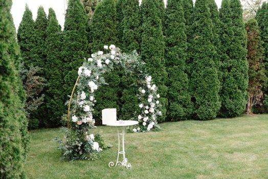 wedding location. Simple wedding location. Not rich. Beautifully decorated wedding ceremony location under a large oak tree, wide view..