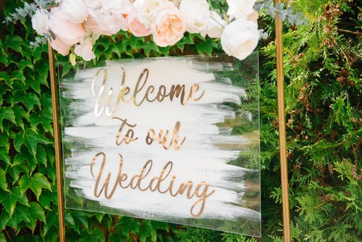 Blank signpost pointer on a wooden easel in a frame with a wreath. Welcome inscription Forest Wedding