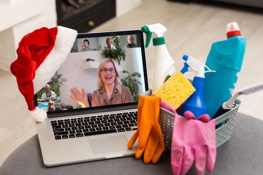 Video Chatting With Woman On Laptop Computer Screen Online next to cleaners and tools.