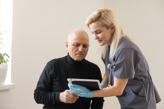 Young nurse taking care of old sick man.