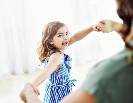 mother and daughter dancing and having fun at home