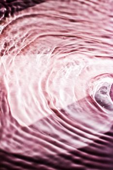 Pink flowing water texture as an abstract background - colourful liquids and creative designs concept. Pink flow