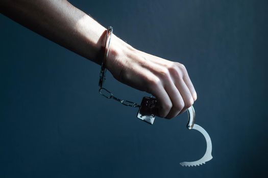 the black handcuffs on wooden background. criminal justice.