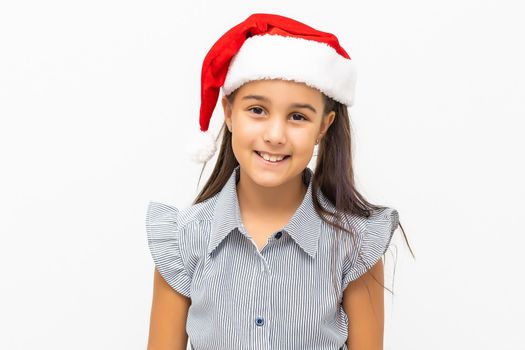 Cute little girl in Santa hat on white background.