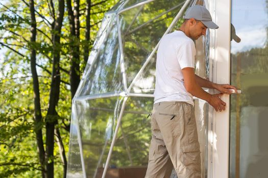 the master builds the dome. Outside spherical glamping dome. Hemispherical structure lattice shell geodesic polyhedron. Camping house hotel party tent