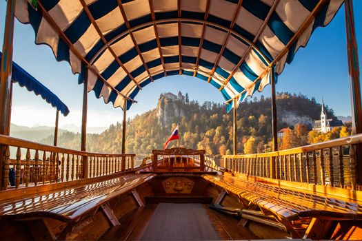 Interior of traditional pletna boat on lake Bled with old castle on the cliff, Bled, Slovenia.