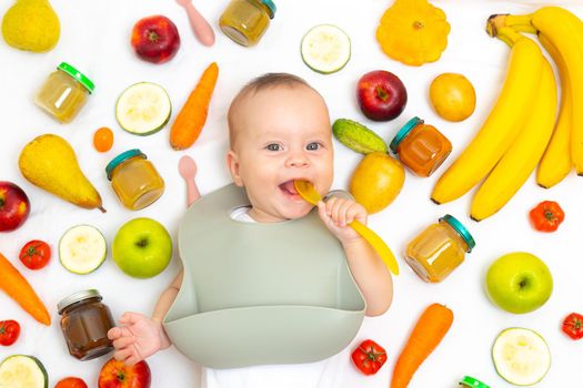 Puree for baby food with vegetables and fruits. Selective focus. nutrition. The first complementary feeding of the child. A happy child. A well- fed child
