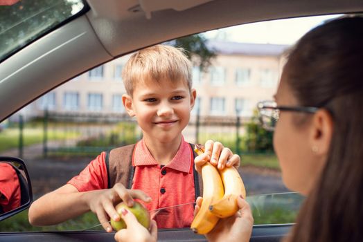 Kid has a school bag and takes gladly his lunch. back to school healthy nutrition concept.