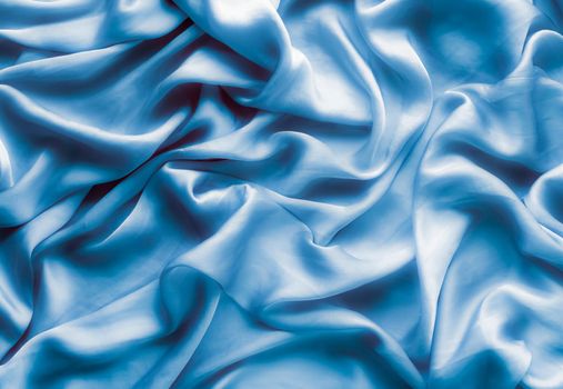 Blue soft silk waves, flatlay - elegant fabric textures, abstract backgrounds and modern pastel colours concept. Feel the touch of luxury