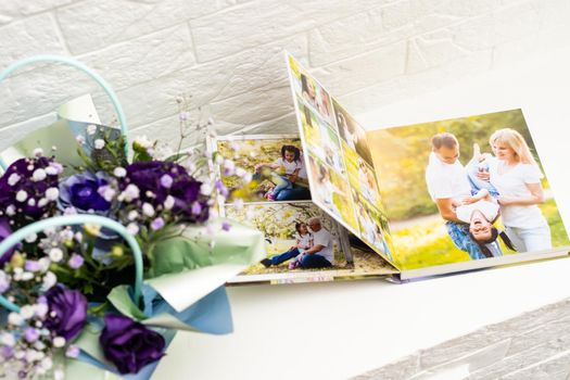 purple bouquet on the photobook on a light background.