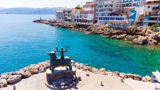 the town of Agios Nicholas on the island of Crete in Greece, in the frame is a bay, a tourist ship and the streets of the city.