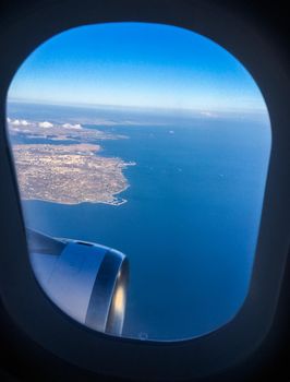 Travel, cloudscape and natural environment concept - View from the airplane window, sky and ocean blue