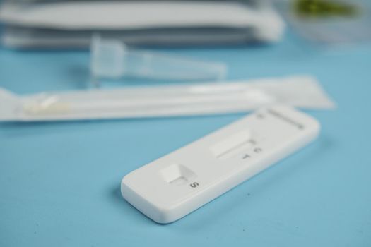 Negative Covid-19 test kit on blue background ,