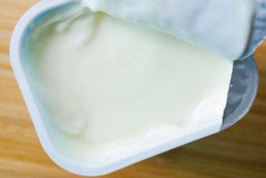 fresh yogurt in a bowl on table .