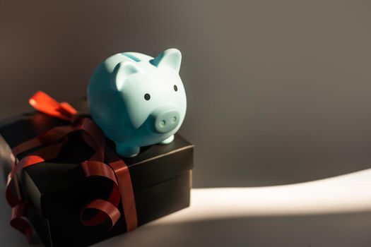Piggy Bank with gift box, worried about money.