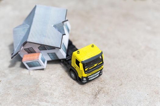 toy trucks with a house on a natural background.