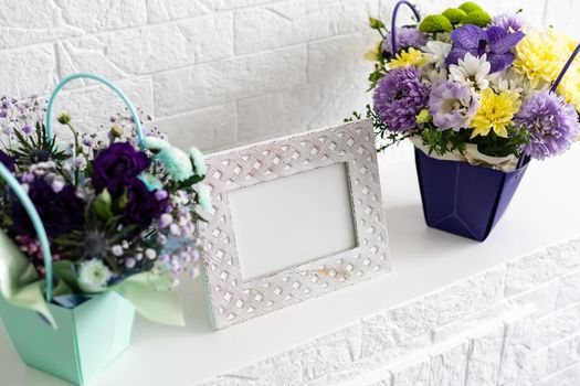 composition with vintage foto frame and purple bouquet.